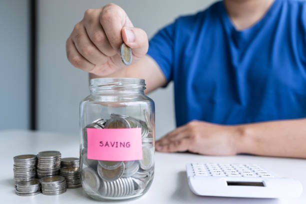 istock Man putting coins to planning growing saving to strategy with money box for future plan fund of travel , education, home and retirement 1197768359