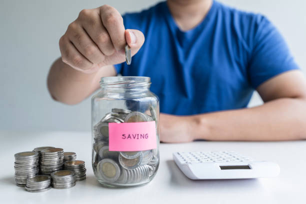istock Man putting coins to planning growing saving to strategy with money box for future plan fund of travel , education, home and retirement 1197768417