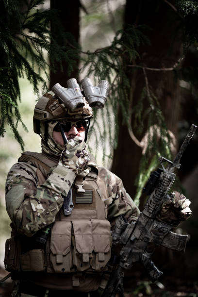 istock Tactical jungle Military man talking on a walkie talkie 1197769301