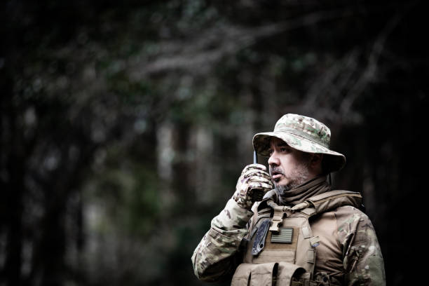 istock Tactical jungle Military man talking on a walkie talkie 1197769375