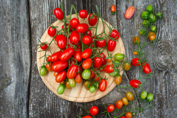 istock beautiful tomatoes on wooden surface 1197772903