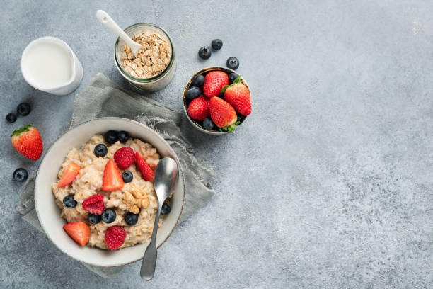 istock Oatmeal porridge with berries top view 1197774884