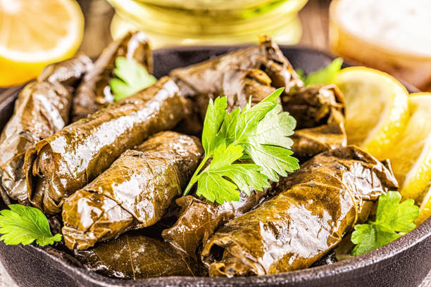 istock Dolma, stuffed grape leaves with rice and meat on dark background, selective focus 1197781763