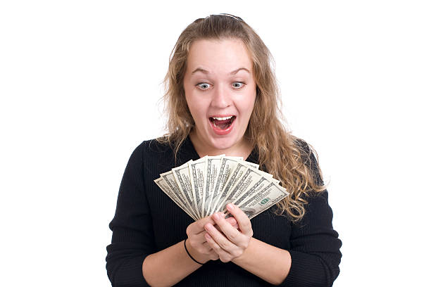 Expressive girl with dollar bills stock photo