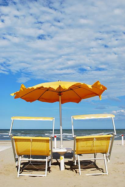 istock Beach chairs and umbrella 119778777