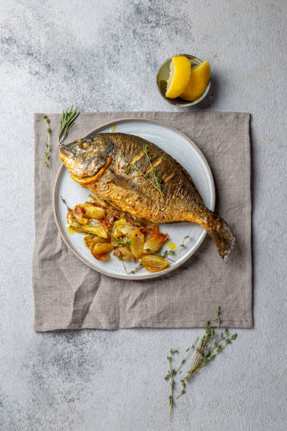 istock Grilled sea bream or dorada on gray plate. Gray background 1197788617