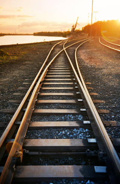 węzeł kolejowy o zachodzie słońca - railroad track direction choice transportation zdjęcia i obrazy z banku zdjęć