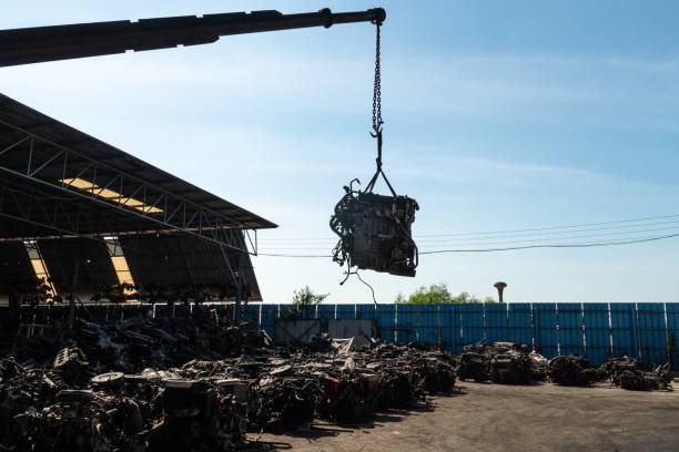 istock A forklift and workers are lifting an old car's engine for recycling. 1197791140