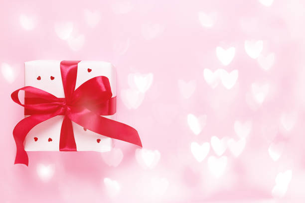 istock White gift box with hearts on a pink background with bokeh. Valentine's day. 1197794106