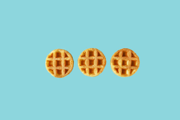 Small round Belgian waffles on trendy blue background