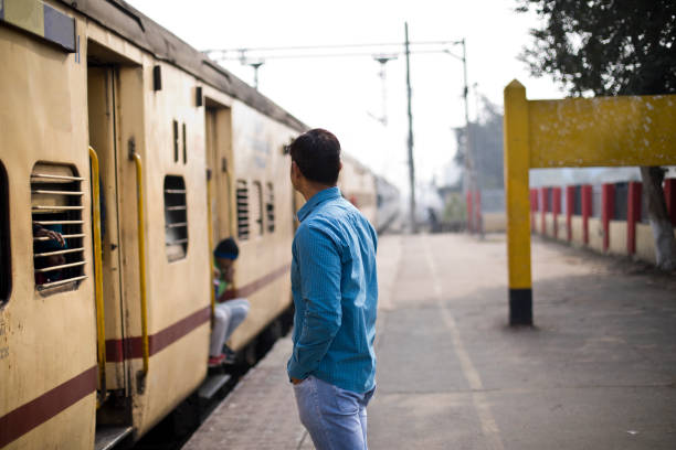 Man waiting at railroad station platform