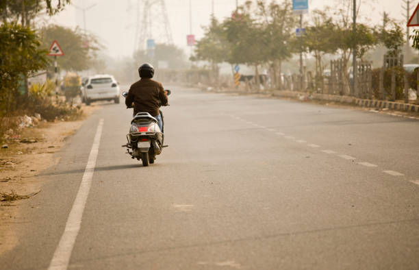 istock Man riding motor scooter in city 1197798661