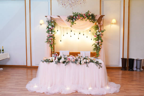istock Wedding table decoration with the pink flowers, grape, lights and greenery 1197799492
