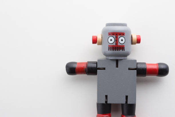 istock wooden robot on white background. 1197800519