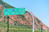Glenwood Springs i70 interstate freeway highway through Colorado with sign on road for Denver, Grand Junction and downtown