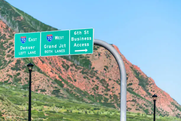 Glenwood Springs i70 interstate freeway highway through Colorado with sign on road for Denver, Grand Junction and downtown