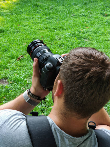 istock man taking picture on professional dslr camera 1197802655