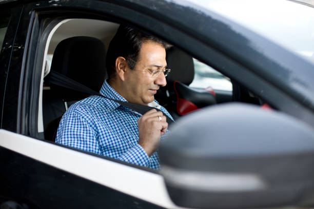 istock Man fastening seat belt in car 1197803541