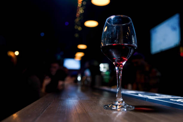 istock Glass of red wine on backlighted background 1197804631