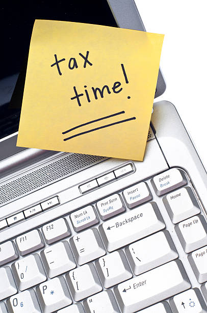 istock Laptop open with note reminding it's tax time  119780554
