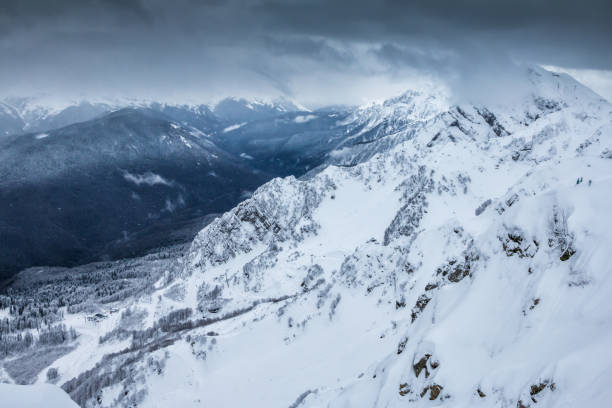 istock High mountain peaks covered with snow on a winter cloudy day 1197806860