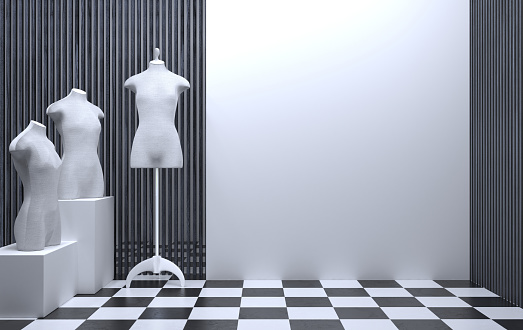 Interior of a sewing workshop or clothing store with a tailor mannequin. White wall showcase with copy space. The room of a fashionable studio for presentations and shows. 3D rendering.