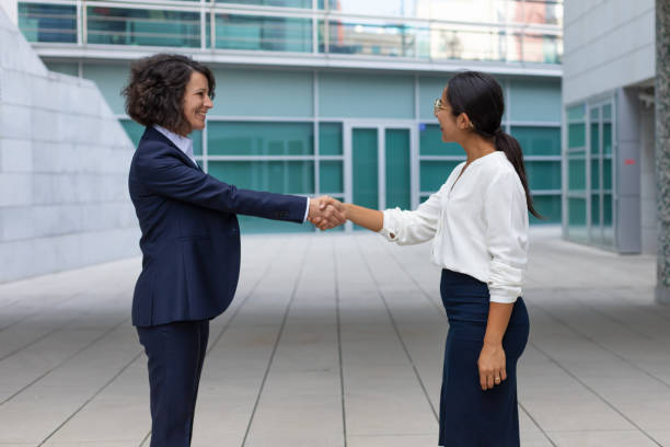 istock Happy female colleagues greeting each other 1197809816
