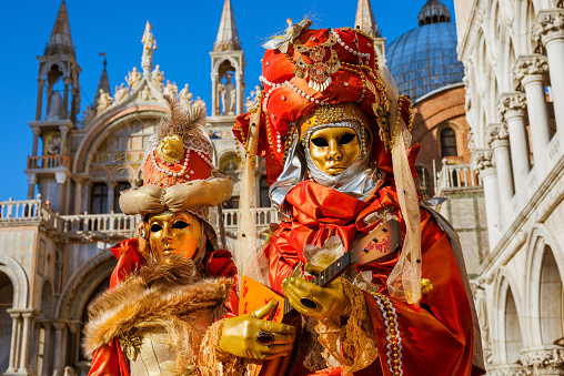 Venice, Italy - February 8, 2015: Closeup portrait of beautiful woman wearing colorful carnival mask