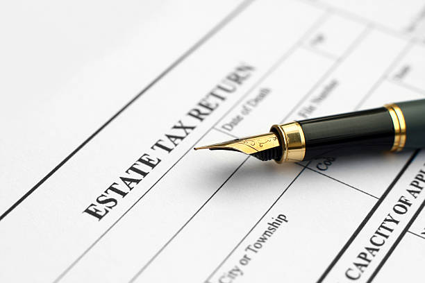 Close up of a fountain pen on top of Estate Tax Return form stock photo