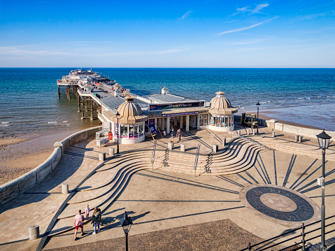 Chichester, England - June 24, 2016: Seafront and shingle beach at Felpham, Bognor Regis in West Sussex, England. With people on promenade