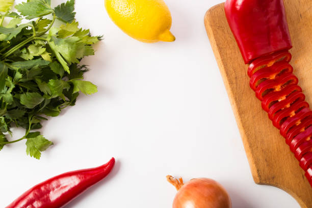 green celery, bell peppers, onions and lemon and centered copy space