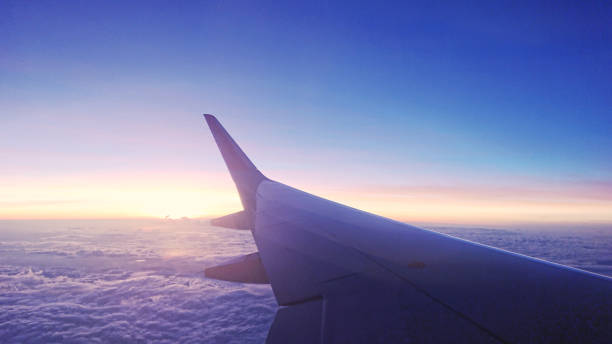 istock Airplane wings with background landscape sky. 1197827902