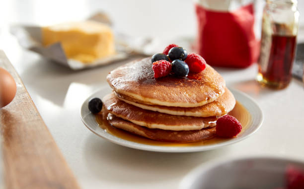 istock Stack Of Freshly Made Pancakes Or Crepes With Maple Syrup And Berries On Table For Pancake Day 1197828486