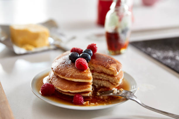 istock Stack Of Freshly Made Pancakes Or Crepes With Maple Syrup And Berries On Table For Pancake Day 1197828963