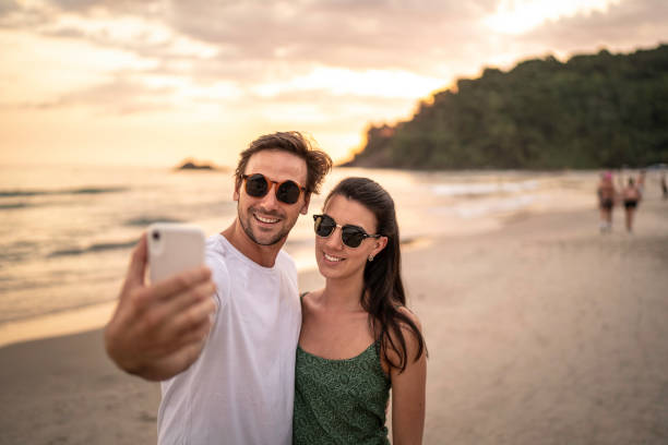 istock Couple taking a selfie on the beach 1197830338