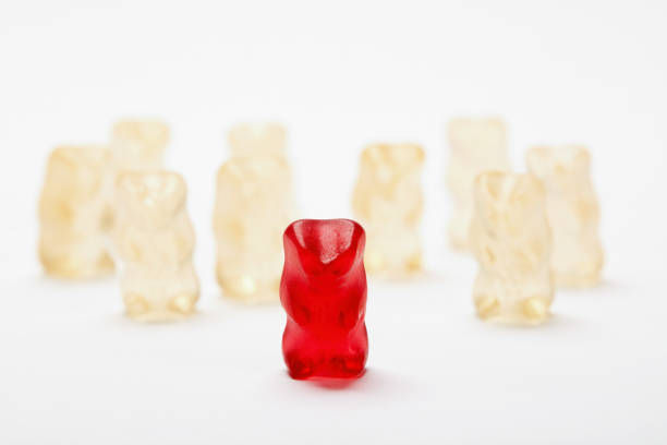 istock Group of gummy bears with one bear being excluded 1197830611