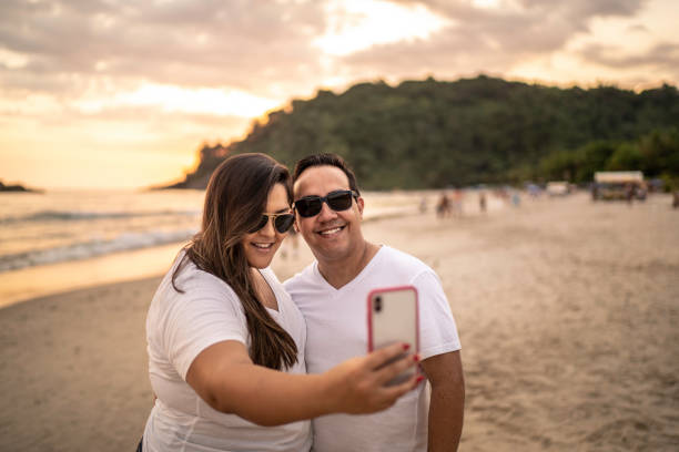 istock Couple taking a selfie on the beach 1197830770