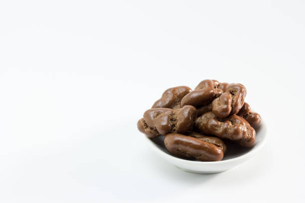 nuts covered with milk chocolate on white background