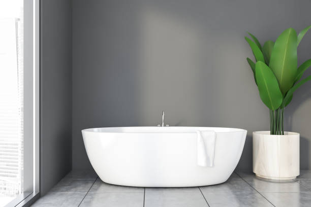 istock Gray bathroom interior with tub and plant 1197831706