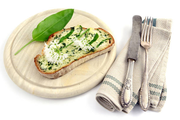 istock Fresh ramson wild garlic bunch with butter bread and antique silverware. white isolated background 1197831836