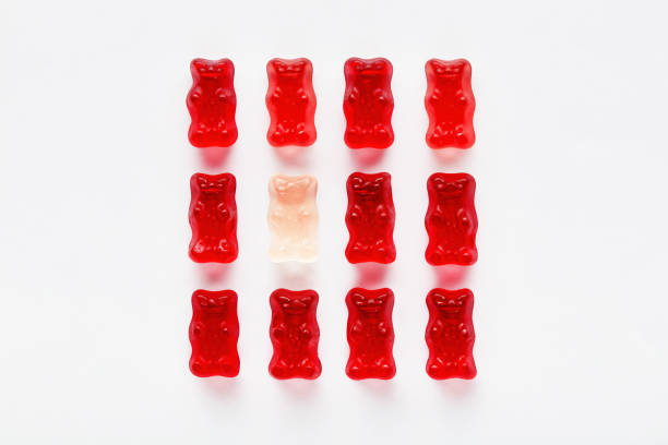 istock White gummy bear among red gummy bears 1197831850