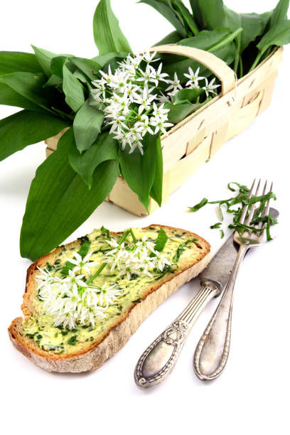 istock Fresh ramson wild garlic bunch with butter bread and antique silverware. 1197831886