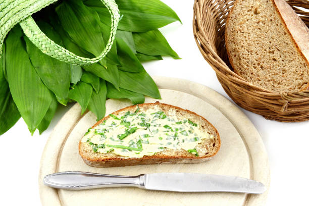 istock Fresh ramson wild garlic bunch with butter bread and antique silverware. white isolated background 1197831962
