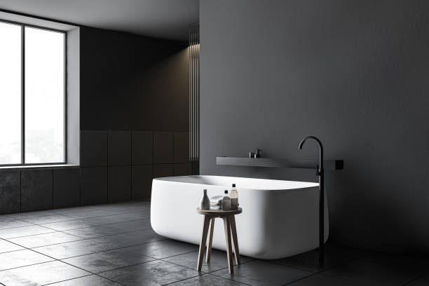 istock Dark gray tiled bathroom corner with tub 1197833073