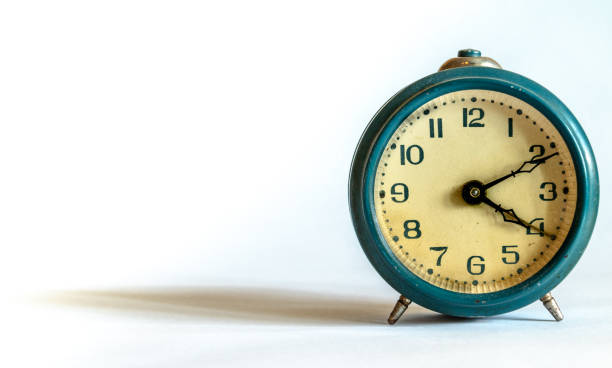 istock Retro blue alarm clock on white background 1197833281