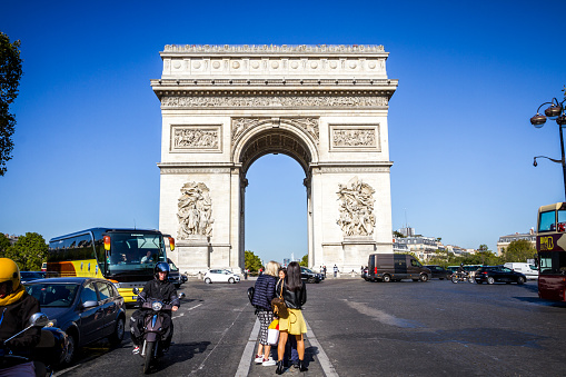 Paris/France - September 10, 2019 : Tourist taking pictures in front of Arc de Triomphe on place de l’Etoile