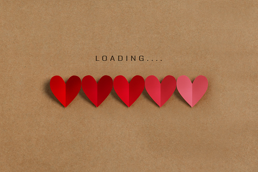 Loading progress bar with red and pink hearts on brown paper background. Valentine's day, Love, Life concepts.