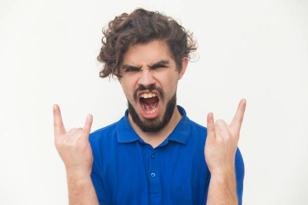 istock Crazy rock and metal fan making devil horns 1197835499