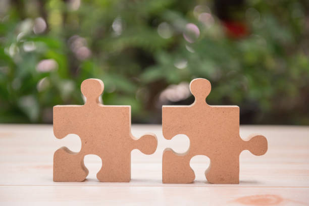 istock successful concept and goal. Business development and improvement. Puzzle and jigsaw connecting with natural background 1197835601