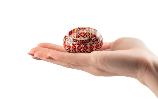 istock Easter egg in woman hand on a white background 1197835959